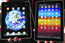 Samsung Electronics' Galaxy Tab 10.1 tablet (R) and Apple Inc's iPad tablet. While the two global majors compete fiercely in the high-end smartphone business  where together they control half the sales and virtually all of the profits  their strengths and weaknesses are in many ways complementary