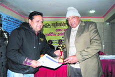 The chief guest presents an award to a winner of the tournament in Mussoorie on Sunday.
