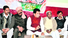 Uttar Pradesh Cabinet minister Sahib Singh Saini meets Samajwadi Party workers in Haridwar on Sunday.