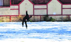 A child plays on the snow-laden ground in Shimla on Saturday