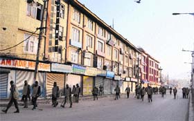 Security personnel patrol Srinagar on the second day of the curfew on Sunday