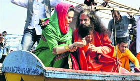 Actress Preity Zinta with Swami Chidanand Saraswati prays at Kumbh Mela in Allahabad on Sunday.