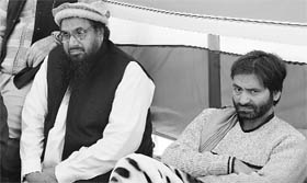 JuD chief Hafiz Saeed (C) with JKLF chairman Yasin Malik (R), who is on fast against the execution of Afzal Guru, in Islamabad on Sunday.