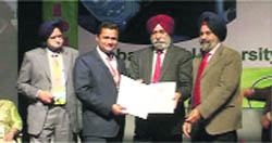 A science teacher receives an award from officials of the Punjab Academy of Sciences in Faridkot. 