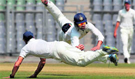 Rest of India player Shikhar Dhawan, who got the nod for the Oz Test series, takes a diving catch during the Irani Trophy match in Mumbai.