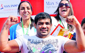 Sushil Kumar flexes his muscles at a promotional event in New Delhi.