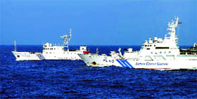 A file photo of a Chinese marine surveillance ship (L) alongside a Japan Coast Guard ship near the disputed Diaoyu islands in China, in the East China Sea.