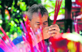 A man prays to mark the Chinese Lunar New Year at a Dharmayana temple on Bali island on Sunday.