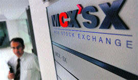 A staff member walks past the MCX-SX logo at their Exchange Square building in Mumbai on Monday.