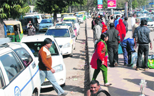 Queue of vehicles parked along side the road at the Chandigarh railway station on Monday.