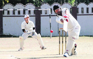 A batsman plays a shot in a match in the 61st Dehradun District Cricket League played at the Survey Stadium in Dehradun on Monday