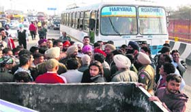 A long queue of vehicles and commuters stranded on the national highway near Phagwara on Monday