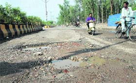 The damaged road leading to Guru Nanakpura level crossing from Ladowali in Jalandhar