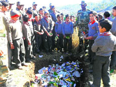 Army officers give tips to schoolchildren on eco-friendly waste management in Rajouri on Monday.
