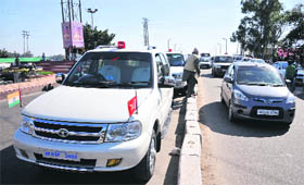A VIP vehicle park alongside flyover obstructs the normal movement of traffic in Jammu on Monday.