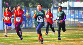 Girls take part in a 100 m race during the athletics meet in Ludhiana on Monday. 