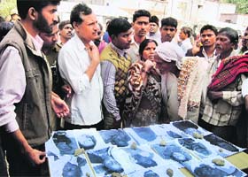 People look at photographs of the dead as they search for their family members in Allahabad on Monday