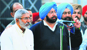 Punjab Pradesh Congress Committee president Capt Amarinder Singh along with party nominee Vijay Kumar Sathi in Moga on Monday.