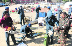NDRF personnel check the equipment to be used in the mega mock drill at the police training grounds in Sector 17, Chandigarh, on Tuesday.