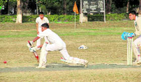 A batsman plays a shot during a match in the RIMC inter-section cricket tournament in Dehradun on Tuesday.