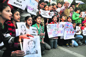  Students and members of the Nationalist Congress Party stage a protest against school authorities for plying old and rickety buses, in Jammu on Tuesday. 