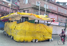 A stall outside the Peer Dastageer Sahib shrine at Sarai Bala lies covered. 