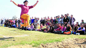 A student of DAV College participates in the long jump event during the 62nd annual athletic meet held in Jalandhar on Tuesday.