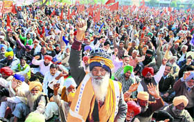 Members of the Joint Platform of Mass Organisations hold a protest in Jalandhar on Tuesday.