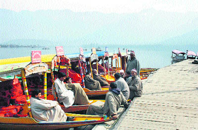 Shikaara owners rest in their boats on the Dal Lake in Srinagar. 