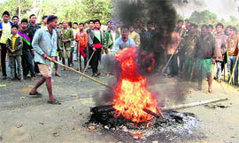 Demonstrators from Rabha tribe block a road at Dorapara in Assams Goalpara district on Tuesday.