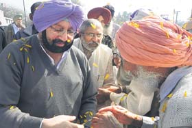Amarinder Singh and Vijay Sathi at Kahansinghwala village on Tuesday