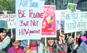 Students take part in a flash mob during a safe sex awareness event to promote the use of condom to prevent spread of HIV infections and sexually transmitted diseases on the occasion of International Condom Day in New Delhi on Wednesday