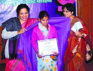 A woman being honoured at a workshop on Violence Against Women organised by the Mahila Samakhaya in Dehradun on Wednesday.
