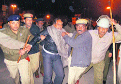 The police arrests a leader of roadways workers outside Fatehabad bus stand on Wednesday. Photo: Sushil Manav