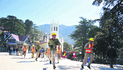 Rescue workers run during a mock drill on the Ridge in Shimla on Wednesday. Photo: Amit Kanwar