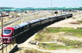In this file photo, a train passes through the main station of Ompora, 20 km of Srinagar