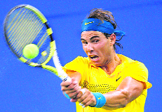 Nadal plays his trademark backhand stroke.