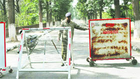 a policeman adjusts barricades on the road leading to the Art college in Sector 10, Chandigarh