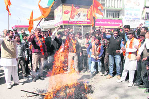 Shiv Sena workers burn an effigy of Valentines Day at Clock Tower in Dehradun on Thursday. 