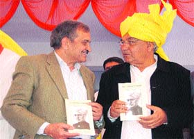 Chief Minister Bhupinder Singh Hooda and AICC general secretary Birender Singh share a point during the release of a book on Ch Chhotu Ram in Rohtak