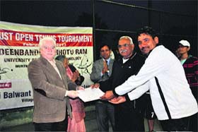 VC HS Chahal and Dr Virender Singh receive prizes from universitys Registrar RK Arora at the closing ceremony of a tennis championship at Murthal recently