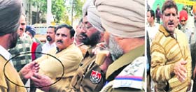 Policemen examine a bullet that was fired at the Model Gram railway station in Ludhiana on Thursday; and (right) the victim, Ashok Kundra