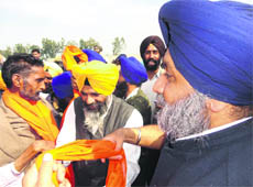 Deputy Chief Minister Sukhbir Badal welcomes Congress activists into the SAD fold at Daddahoor village in Moga on Thursday.