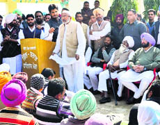 Congress candidate Vijay Sathi addresses a gathering as other party leaders, including PPCC chief Capt Amarinder Singh, look on at Daulatpura village on Thursday. 