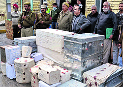 Officials with consignments of seized narcotics before destroying them in Amitsar on Friday