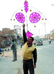 A man tries to fly a huge kite during the Basant Panchami celebrations in Bathinda on Friday.