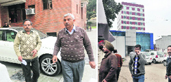 Income Tax officials come out after raiding the house of CMD, Synergy Thrislinglton, at Sector 19, Chandigarh; and officials at Mohali. Tribune photos: Vicky Gharu and Manoj Mahajan