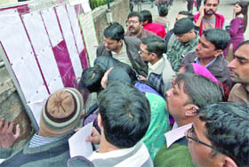 Parents scanning the second list for nursery admissions at Bal Bharati Public School, Pusa Road in New Delhi on Friday. 