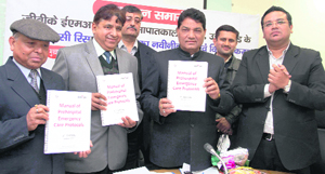 State Health Minister Surinder Singh Negi (second from right) releases a manual at a function in Dehradun on Friday.