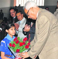 A student welcomes Governor NN Vohra during the SaMaPa Aalap Festival in Jammu on Thursday. Tribune photo: Anand Sharma
